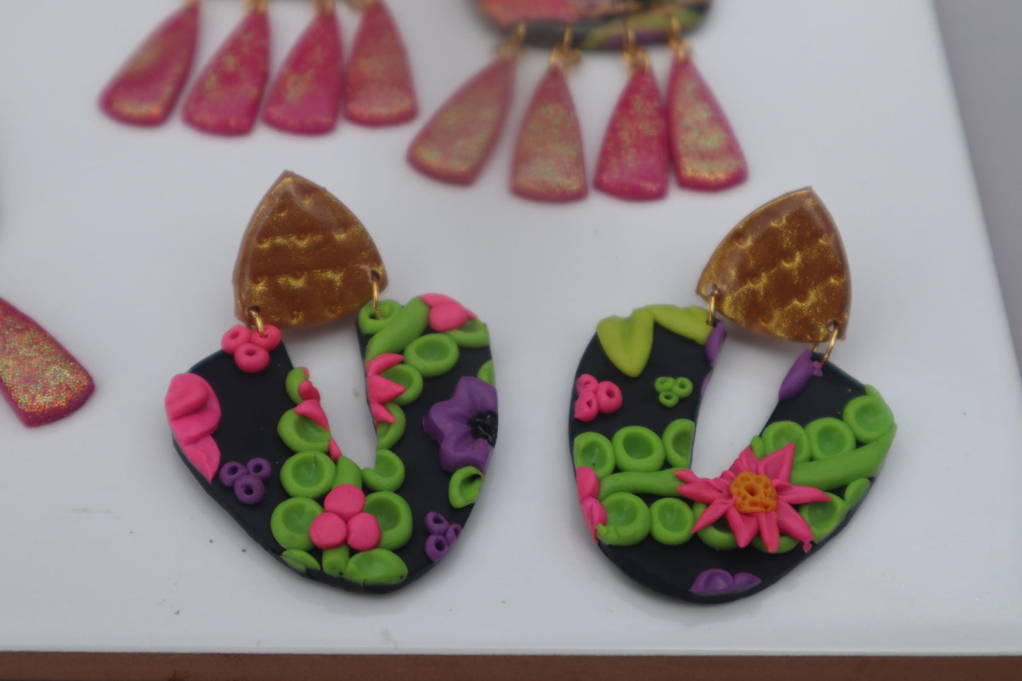 VC pick ‘a’ mix arch dangles. Mixed media. Have small flaws. All are discounted and have nickel free findings and resin backs ‘Summer days’