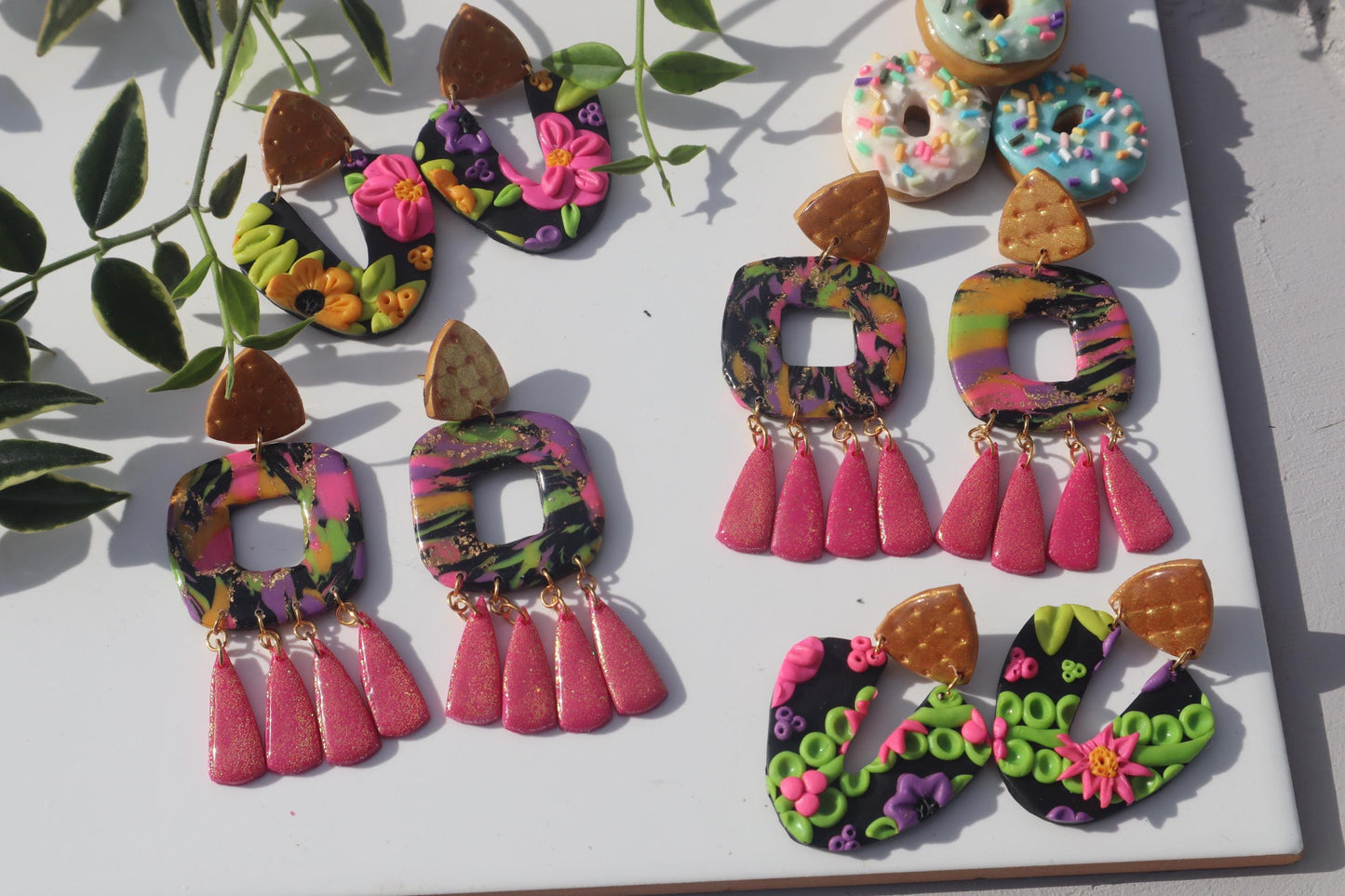 VC pick ‘a’ mix arch dangles. Mixed media. Have small flaws. All are discounted and have nickel free findings and resin backs ‘Summer days’