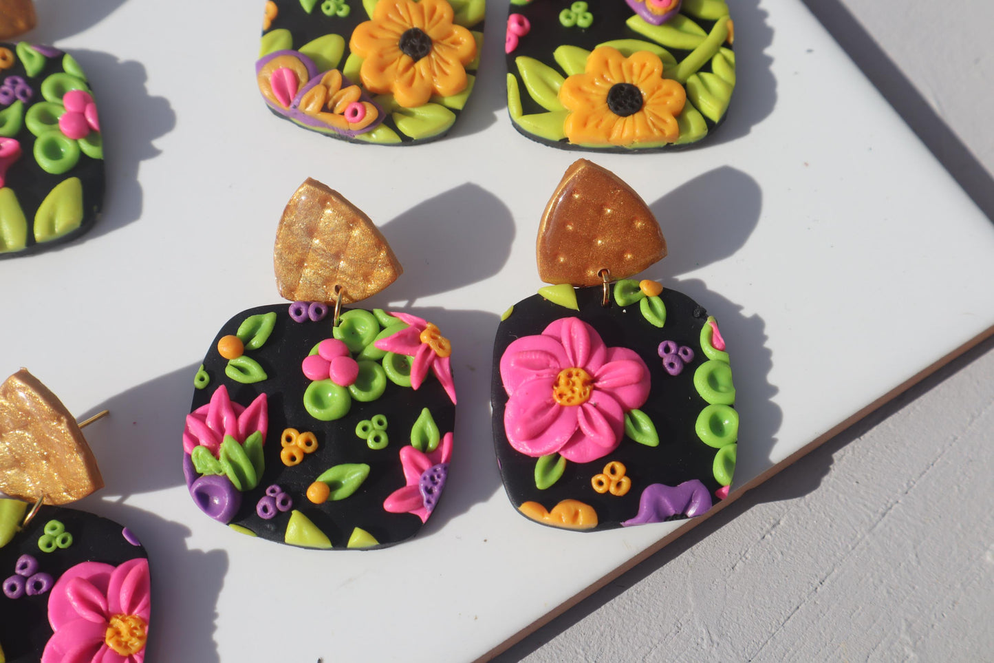 VC pick ‘a’ mix square dangles Mixed media. Have small flaws. All are discounted and have nickel free findings and resin backs ‘Summer days’